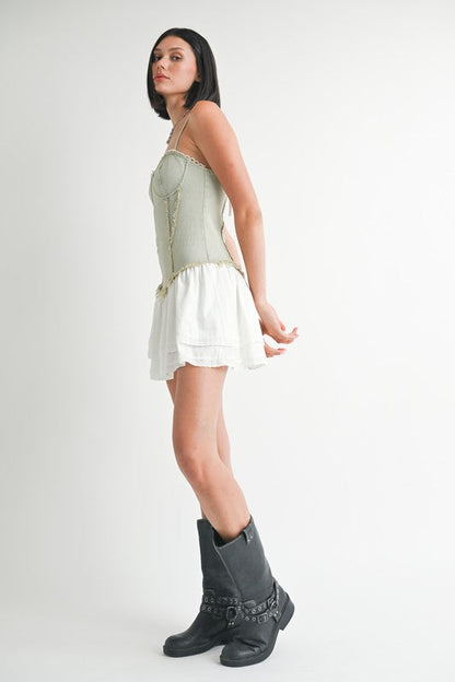 Mini sleeveless denim dress by Jade Icarus, styled with automotive-inspired design elements and visible stitching details.