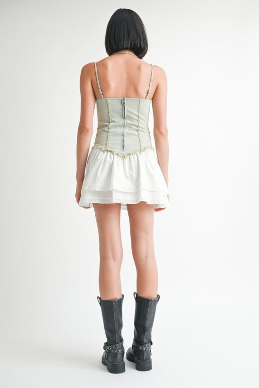 Mini sleeveless denim dress by Jade Icarus with automotive-inspired design, featuring a sleeveless cut and denim fabric.