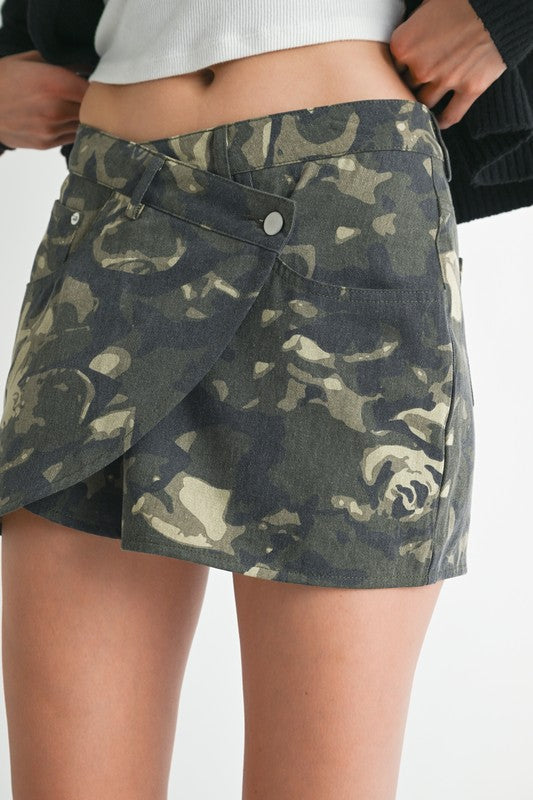 Automotive wrapped mini skirt with button details from Jade Icarus, featuring a sleek design and button accents.