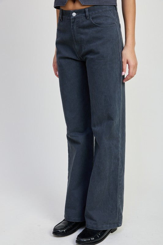 Fitted denim pants folded neatly, featuring classic stitching and a Jade Icarus label, suitable for automotive style enthusiasts