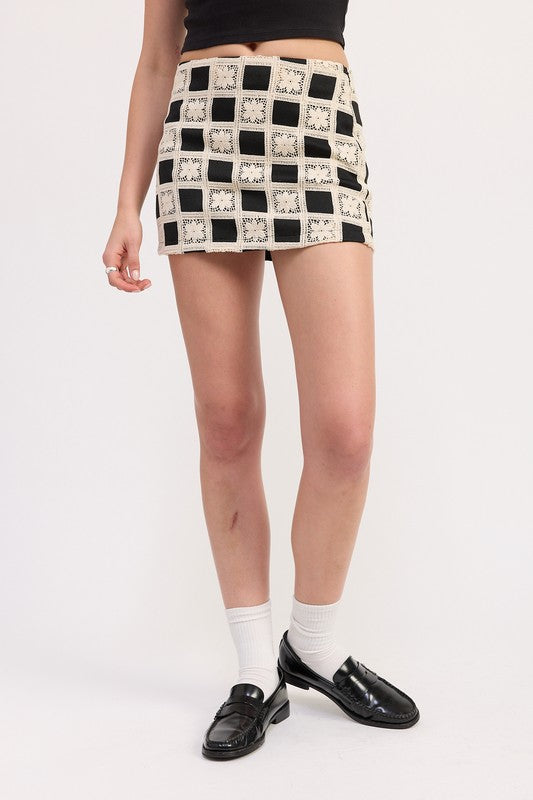 Automotive mini jacquard skirt by Jade Icarus featuring detailed fabric pattern and tailored fit.