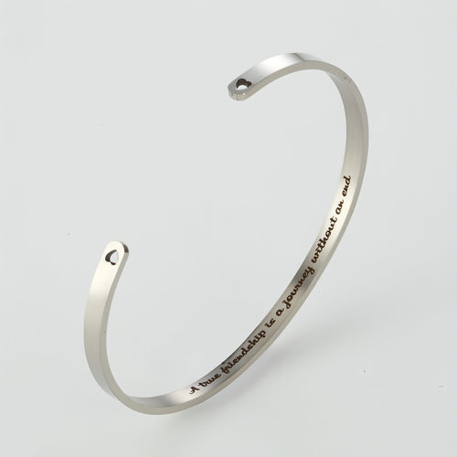 Personalized steel couple bracelet for him and her, sleek design by Carmine Juneberry, featuring engraved custom details.