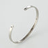 Personalized steel couple bracelet for him and her, sleek design by Carmine Juneberry, featuring engraved custom details.