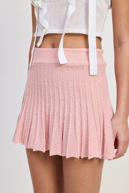 Jade Icarus pleated mini skirt for automotive styling, featuring a sleek, fitted design with pleats and modern detailing.