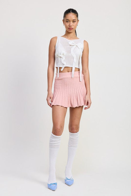 Automotive Jade Icarus pleated mini skirt with sleek design and vibrant color, shown on a model.