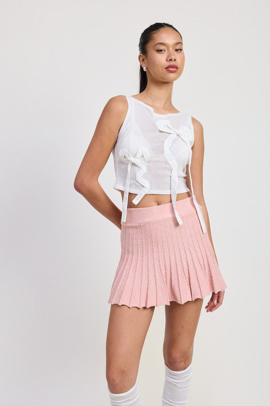Jade Icarus pleated mini skirt in vibrant automotive fabric, shown with detailed pleats and stylish design.