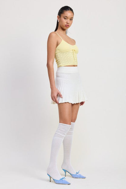 Automotive Jade Icarus pleated mini skirt featuring sleek design and fabric details, displayed on a model.