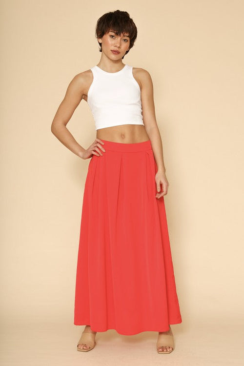 Automotive high waist pleated skirt by Jade Icarus, featuring a sleek design and pleated fabric pattern.