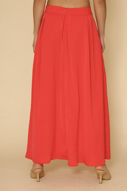 Automotive high waist pleated skirt by Jade Icarus featuring sleek design and detailed pleats, displayed on a mannequin.