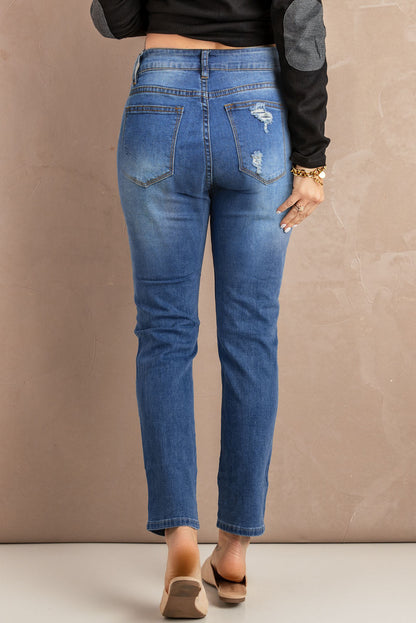 Blue hollow-out vintage skinny ripped jeans by Harlequin Daisy, showcasing distressed denim style and slim fit.
