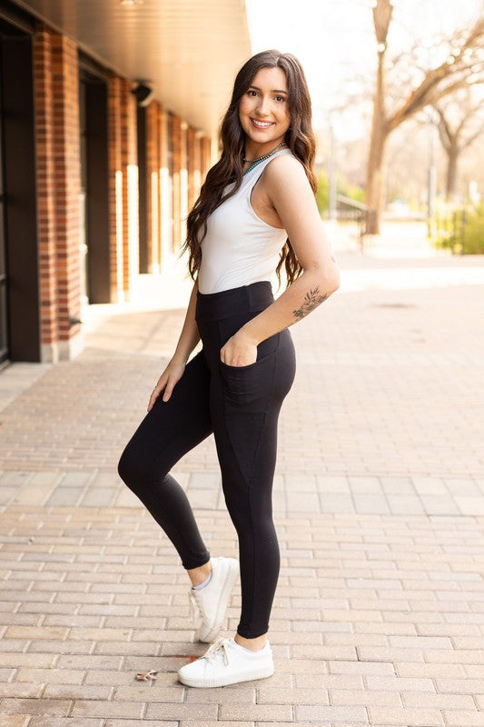 Full-length Jade Icarus Sleek Pocket Collection leggings for automotive wear, shown in black with pockets and a smooth fit.