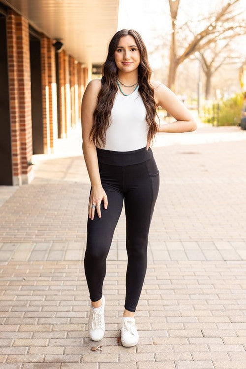 Jade Icarus Sleek Pocket Collection full-length automotive leggings, featuring a smooth black fabric and subtle pocket details.