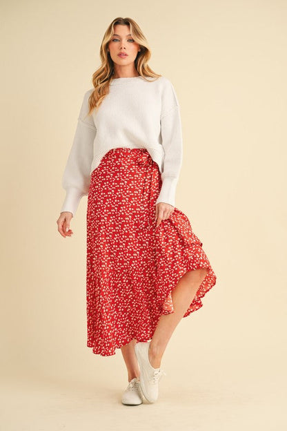 Automotive part from Jade Icarus featuring a Berti Floral Wrap Skirt design in vibrant colors, detailed with floral patterns.