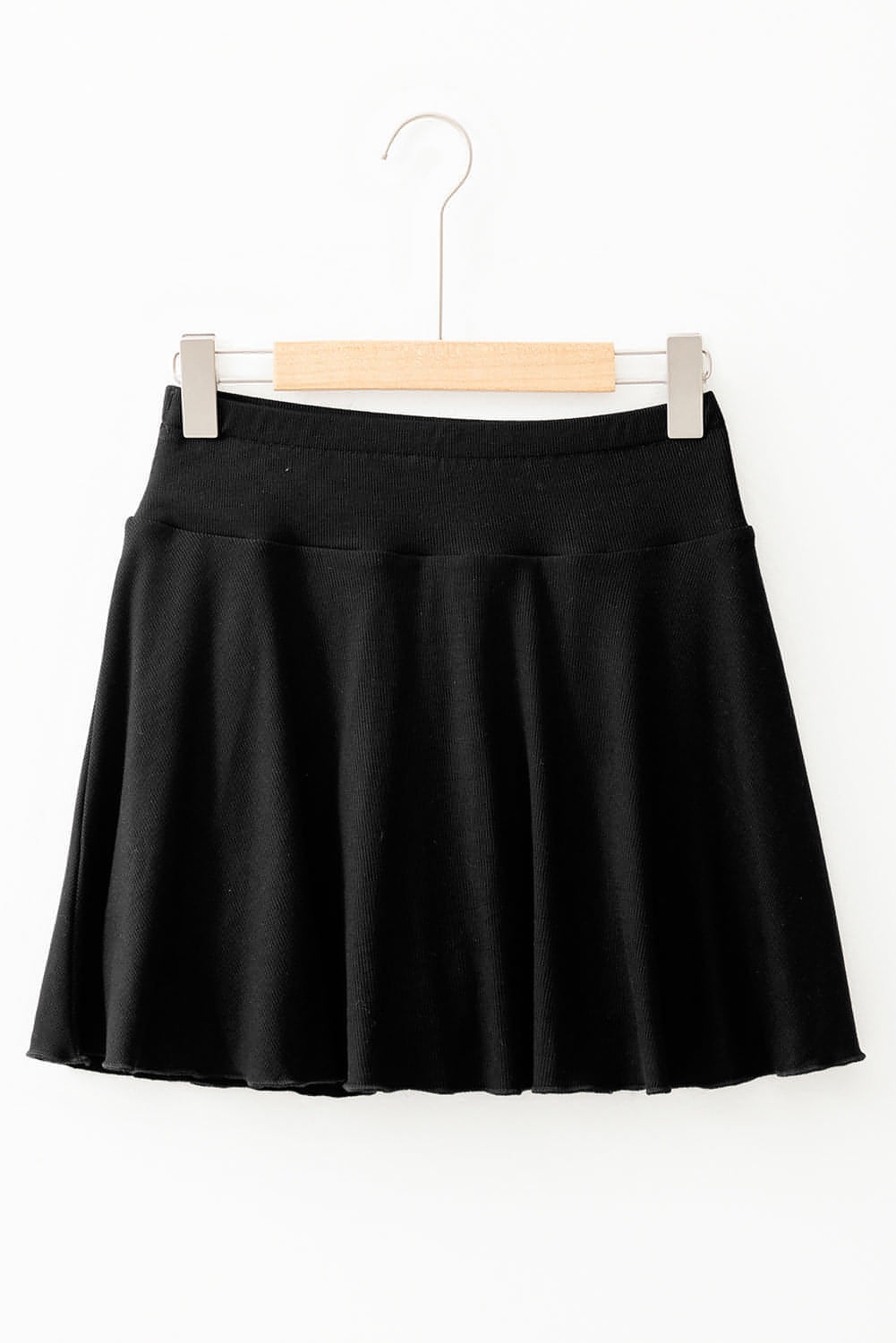 Black Carmine Juneberry A-line skort featuring draped high waist design, phone pocket, and lined fabric for casual style.