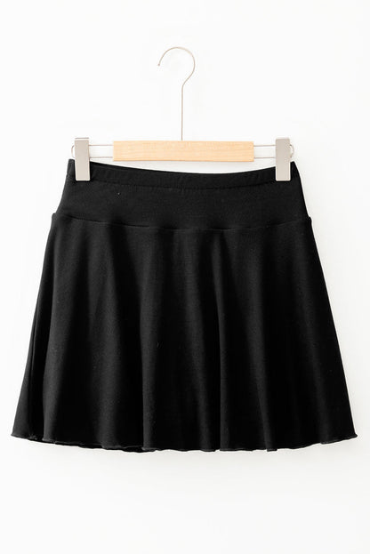 Black Carmine Juneberry A-line skort featuring draped high waist design, phone pocket, and lined fabric for casual style.