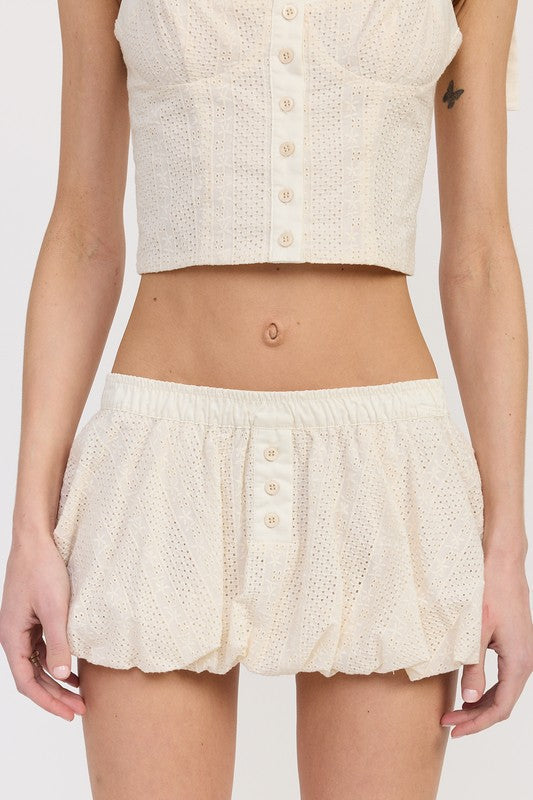 Jade Icarus Bubble Mini Skirt with elastic waistband, showcasing its stylish design and comfortable fit in a close-up view.