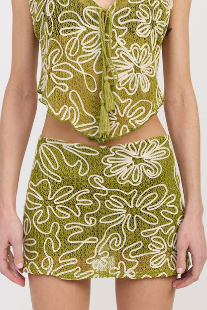 Automotive low rise printed mini skirt designed by Jade Icarus, featuring bold patterns and a sleek fit.