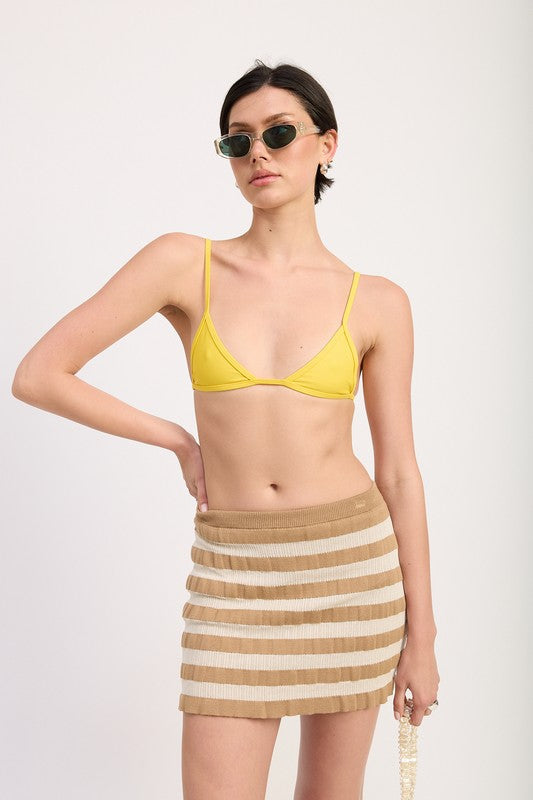 Striped ribbed knit mini skirt from Jade Icarus, styled with automotive-themed design elements and vibrant color accents.