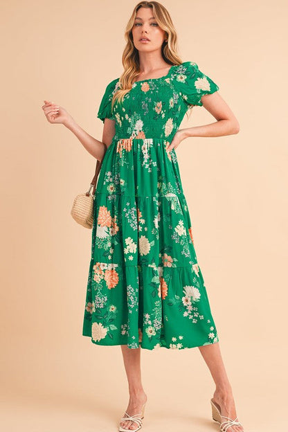 Green tiered lightweight midi dress for women by Jade Icarus, flowing fabric with layered design and sleeveless style.