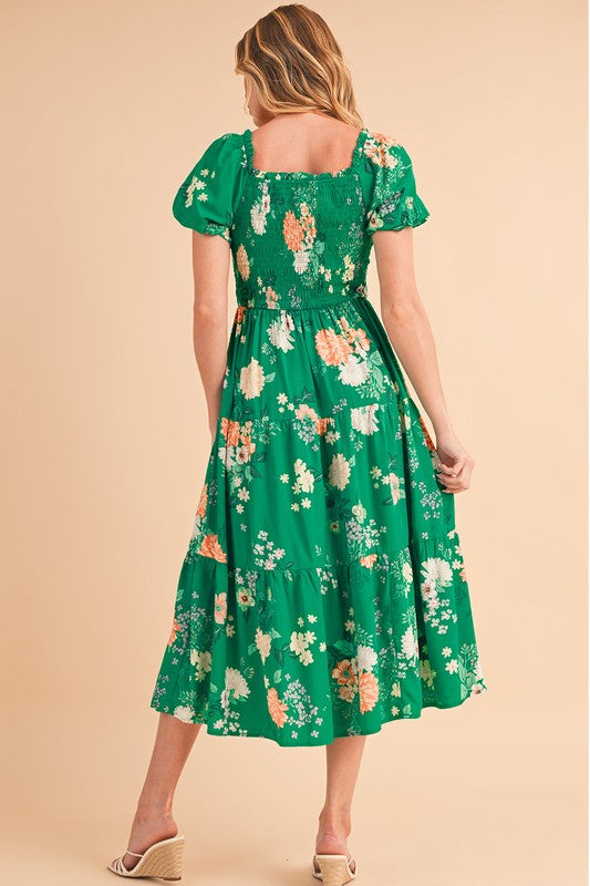 Green tiered lightweight midi dress for women by Jade Icarus, flowing fabric with layered design and sleeveless style.