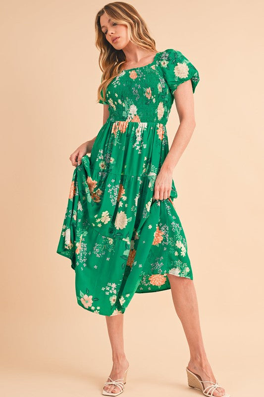 Green tiered lightweight midi dress for women by Jade Icarus, flowing design with multiple tiers and sleeveless style.