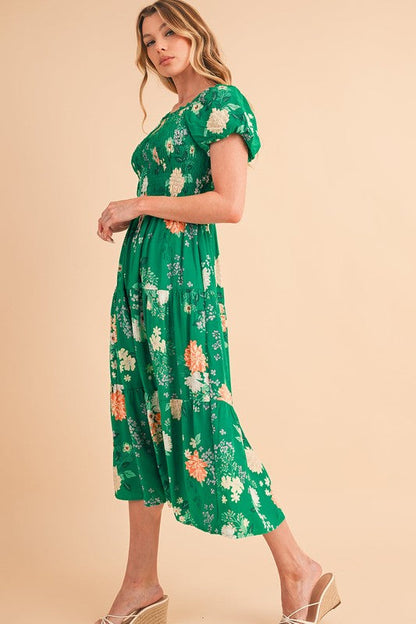 Green tiered lightweight midi dress for women by Jade Icarus, flowing design with layered fabric and sleeveless style.