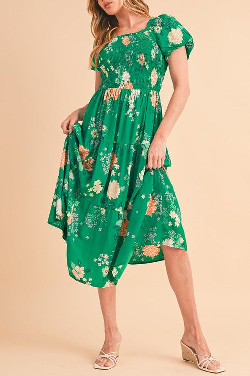 Green tiered lightweight midi dress for women by Jade Icarus, flowing fabric with a stylish tiered design.