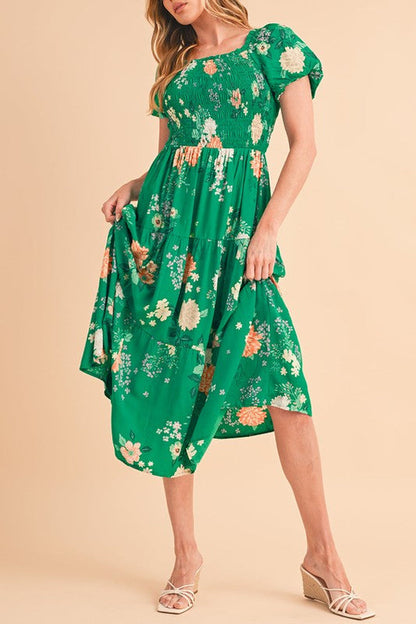 Green tiered lightweight midi dress for women by Jade Icarus, flowing fabric with a stylish tiered design.