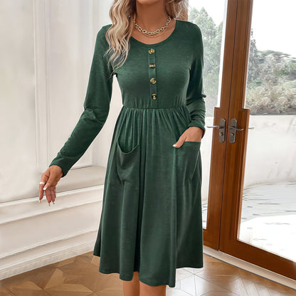 Carmine Juneberry waist-tight knitted long-sleeved dress with round neck, button front and pocket details, in a close-up view.