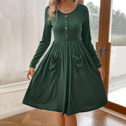 Carmine Juneberry waist-tight knitted long-sleeve dress with round neckline and button pocket detail, in a stylish and fitted design.