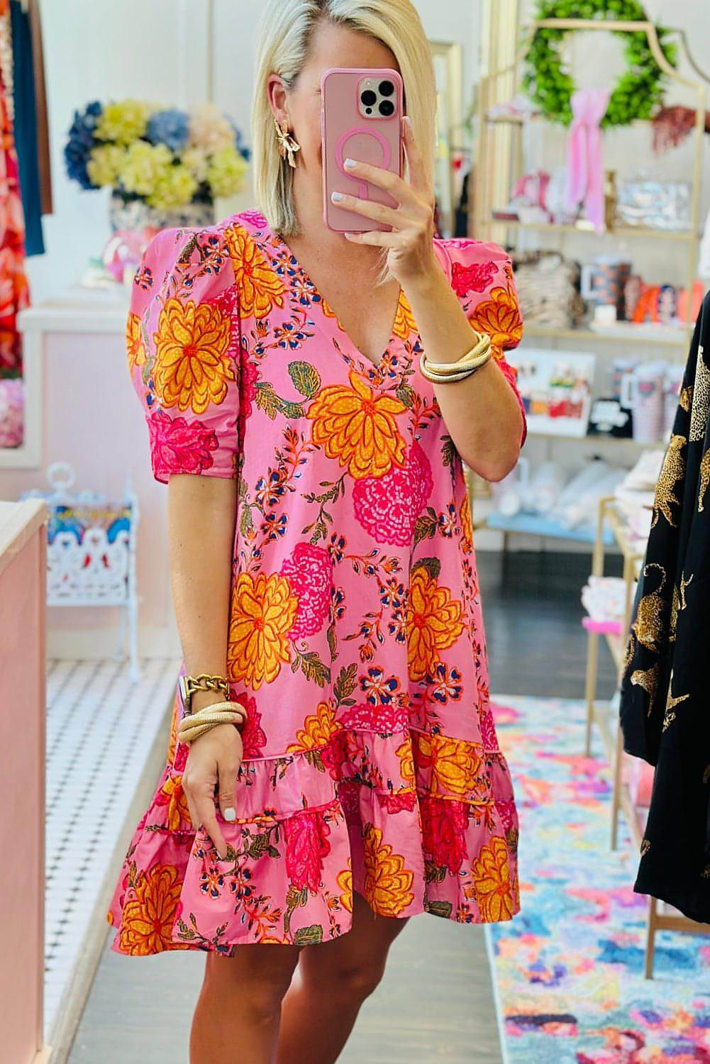 Pink floral bubble sleeve V-neck ruffled mini dress by Carmine Juneberry, featuring a feminine design with floral patterns and ruffle details.