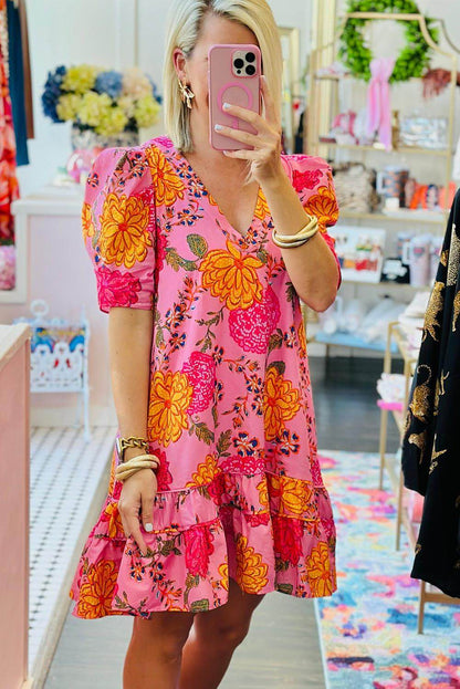 Pink floral bubble sleeve V-neck ruffled mini dress by Carmine Juneberry, featuring a feminine design with floral patterns and ruffle details.
