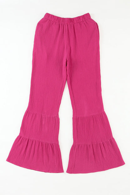 Rose textured high waist ruffled bell bottom pants by Carmine Juneberry, featuring a floral pattern and wide-leg silhouette.