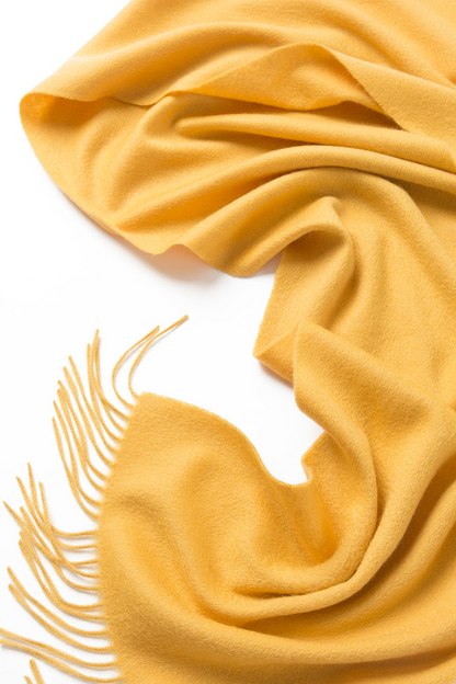 Yellow woven lambswool scarf from Start2Finish, showcasing a plain, soft, and cozy apparel accessory with textured fabric.