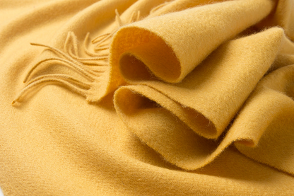 Yellow woven lambswool scarf from Start2Finish with a plain design, soft texture, and fringed edges.