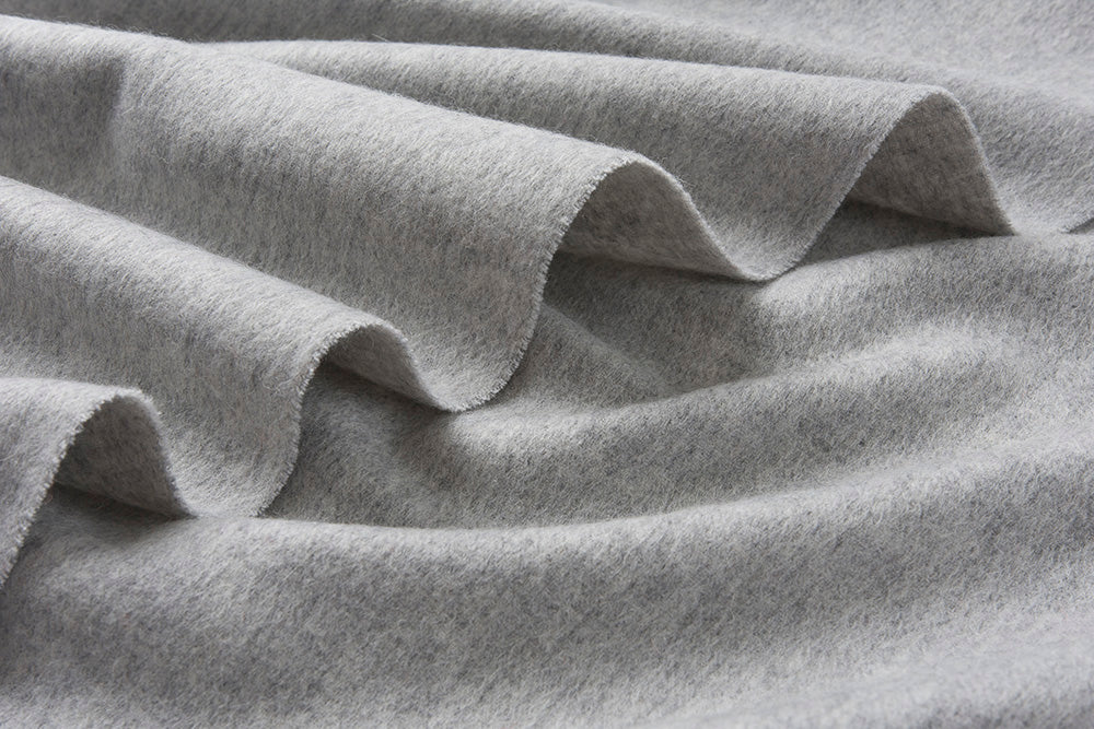 Light grey woven lambswool scarf from Start2Finish, showcasing its soft texture and simple, plain design.