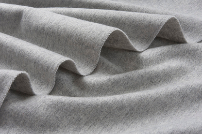 Light grey woven lambswool scarf from Start2Finish, showcasing its soft texture and simple, plain design.