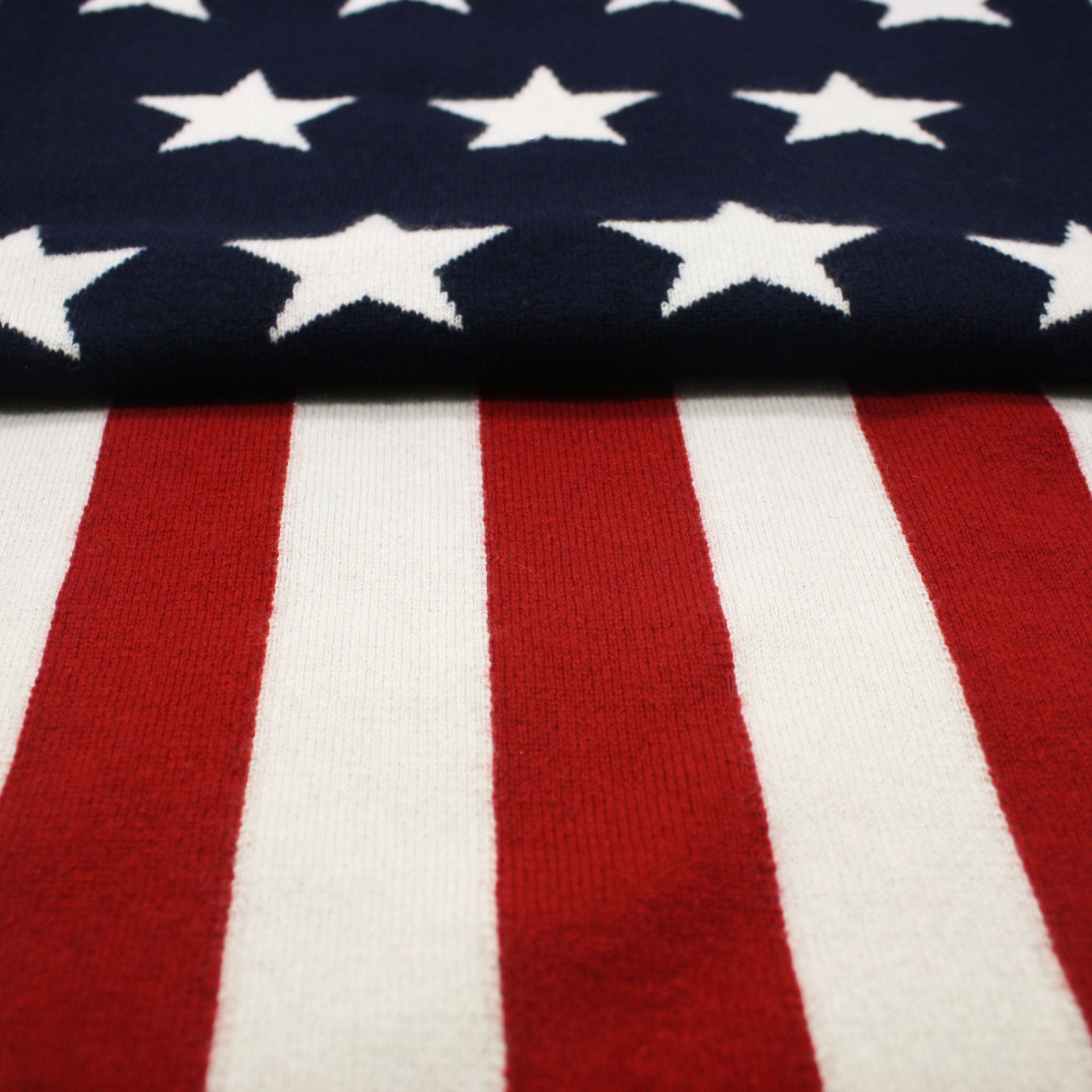 American flag knitted cashmere scarf from Start2Finish, featuring red, white, and blue stars and stripes in soft, warm fabric.