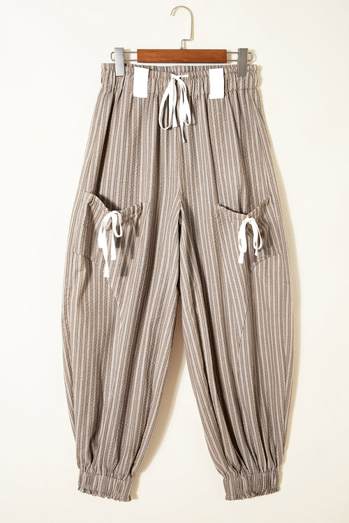 Byzantium Bay stripe drawstring cargo jogger pants with side pockets and tapered fit, shown on a model.