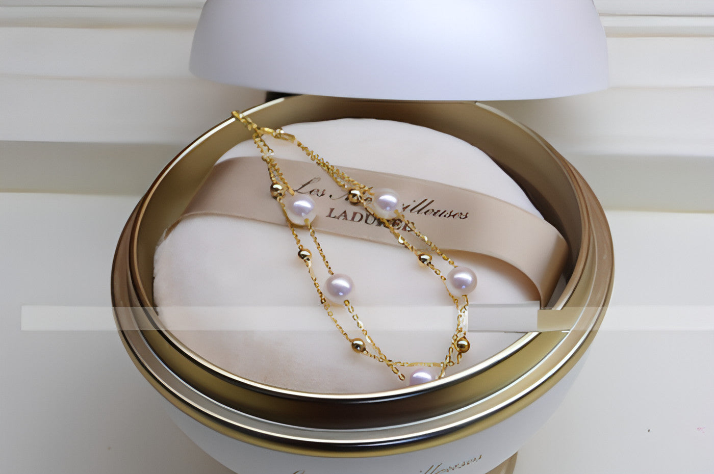 18k gold seawater pearl adjustable double-layer bracelet by Carmine Juneberry, featuring elegant pearls and layered design.