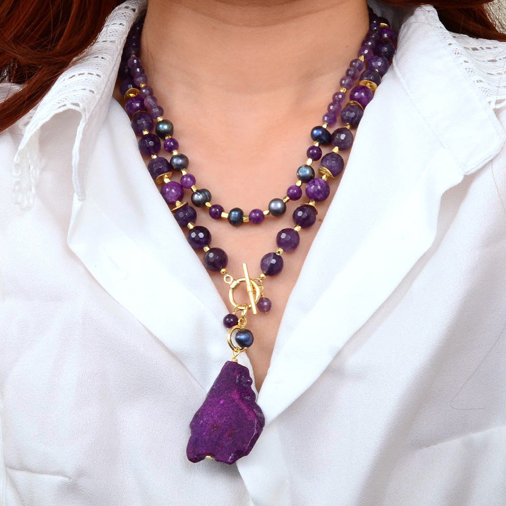 Purple amethyst and jasper pendant necklace featuring a gold-tone jewelry piece with intricate design details.