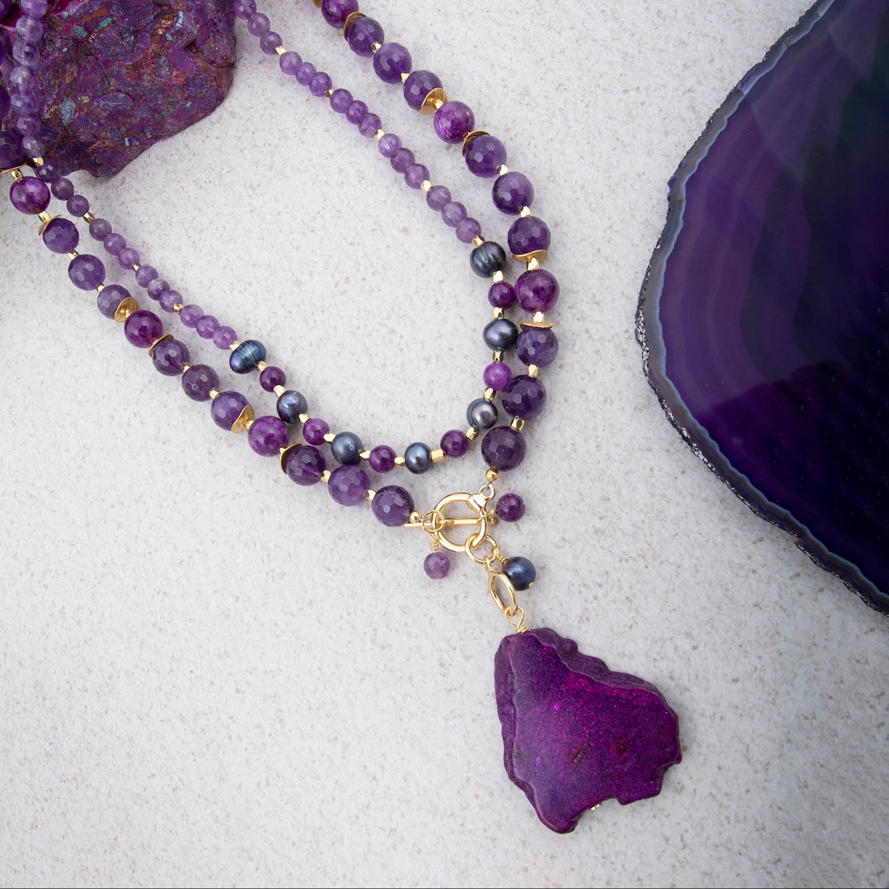 Purple amethyst and jasper pendant necklace with gold accents, jewelry piece featuring a polished gemstone pendant.
