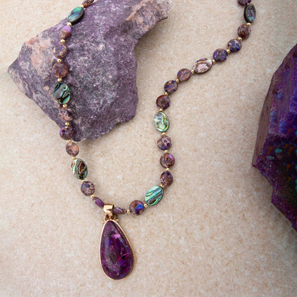 Purple turquoise and gold pendant necklace from Start2Finish jewelry featuring a detailed gemstone pendant on a chain.