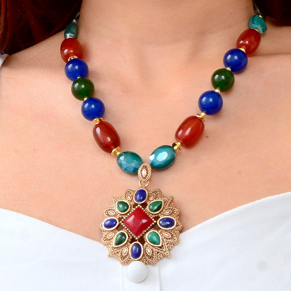 Luscious red quartz golden pendant jewelry featuring a sparkling jeweled red quartz stone with a gold setting.