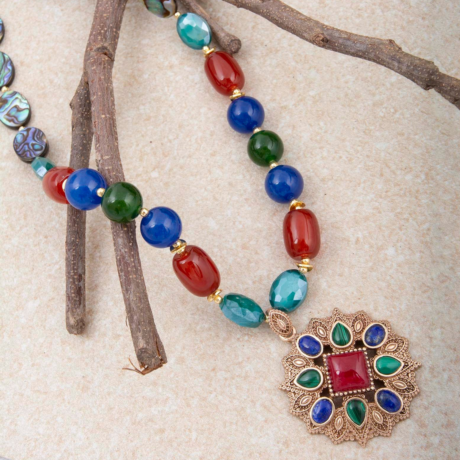 Luscious jeweled red quartz pendant with gold setting, elegant jewelry piece featuring vibrant red gemstone and intricate gold details.