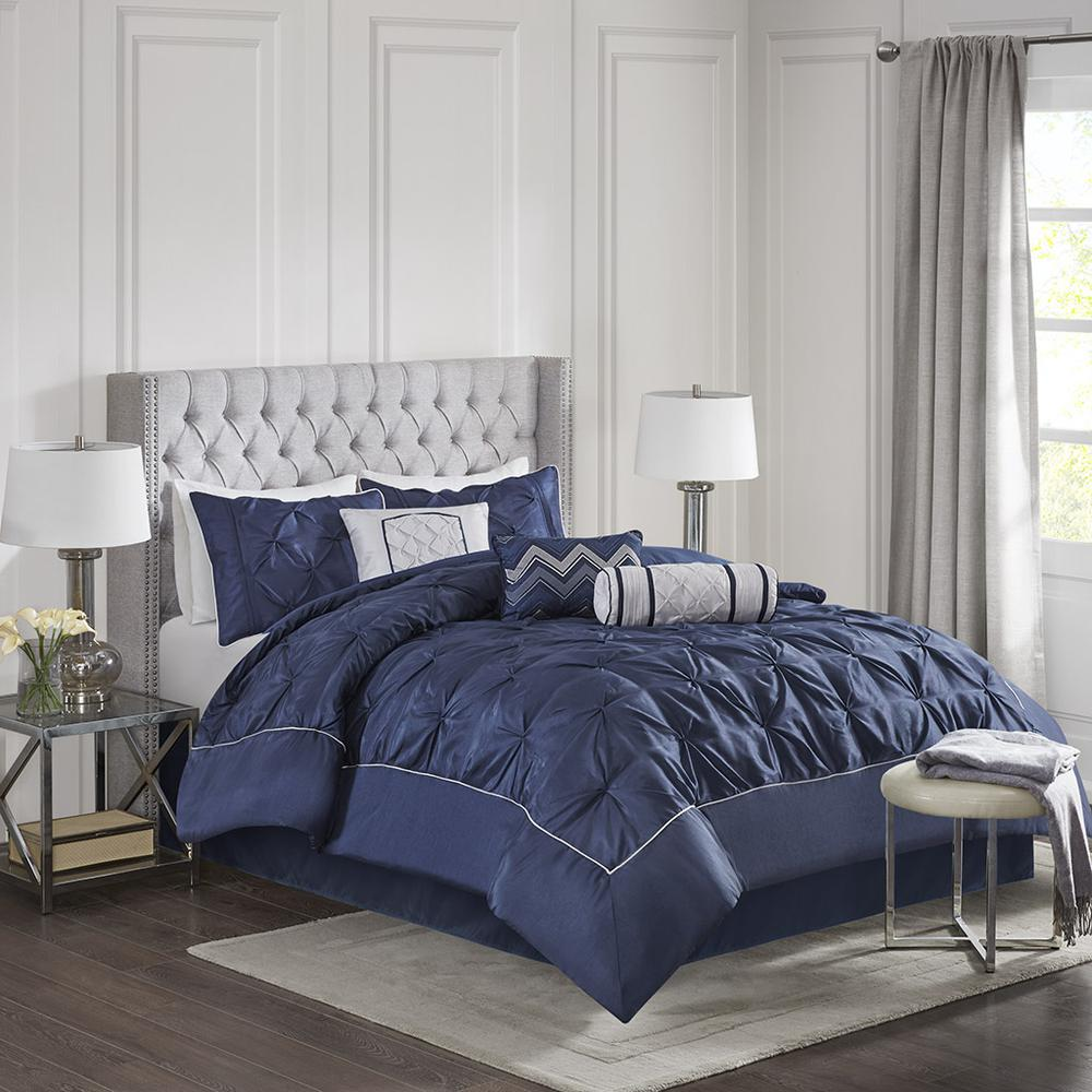 Navy Laurel 7-piece tufted comforter set by Start2Finish with coordinating pillow shams and decorative pillows on a bed.
