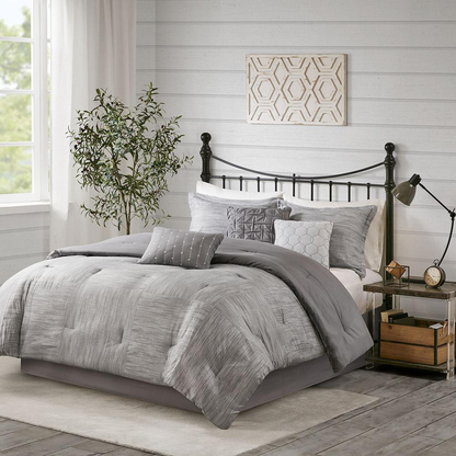 Start2Finish 7-piece printed seersucker comforter set with matching pillow shams and decorative pillows on a bed.