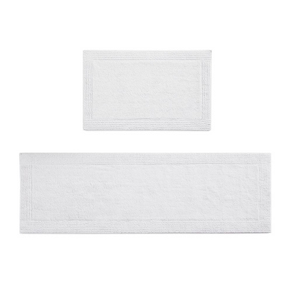 Reversible 100% cotton bath rug with 3000 GSM, featuring a tufted design in neutral tones for plush comfort and style.
