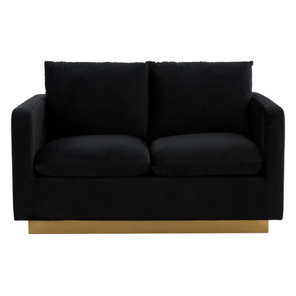 Modern mid-century velvet loveseat with gold frame, upholstered in plush fabric, featuring sleek design and elegant craftsmanship.