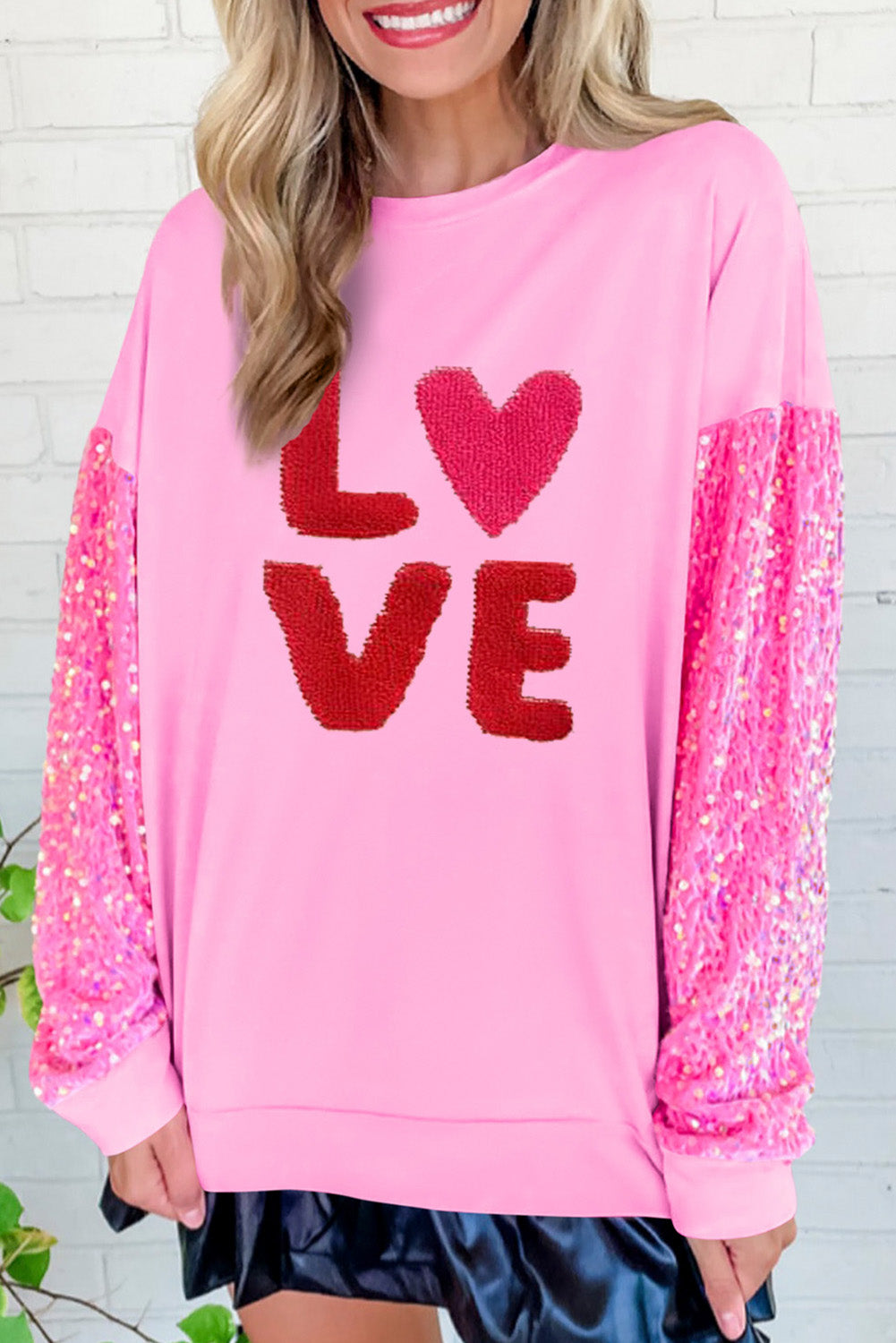 Pink Valentines LOVE chenille embroidered sequin sleeve sweatshirt by Harlequin Daisy, featuring soft fabric and decorative detailing.